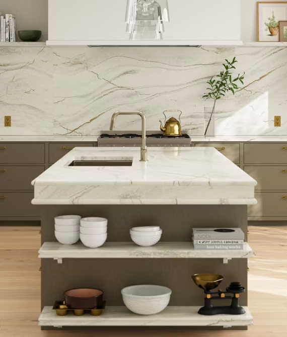 Modern kitchen with marble island and decor.