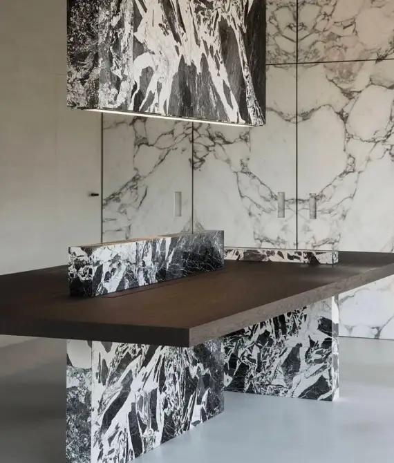 Modern kitchen with marble and wood decor.