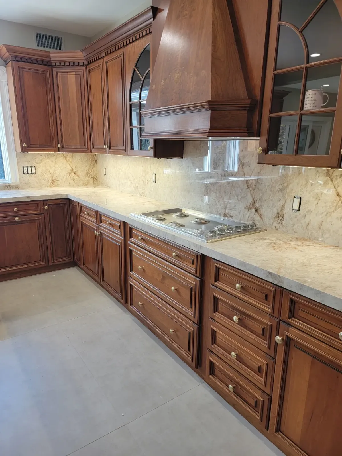 Wooden kitchen cabinets with marble countertops.