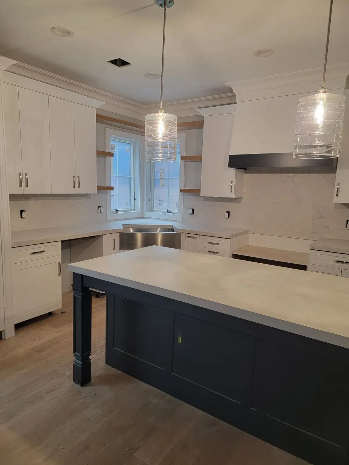 Modern kitchen with island and pendant lights.