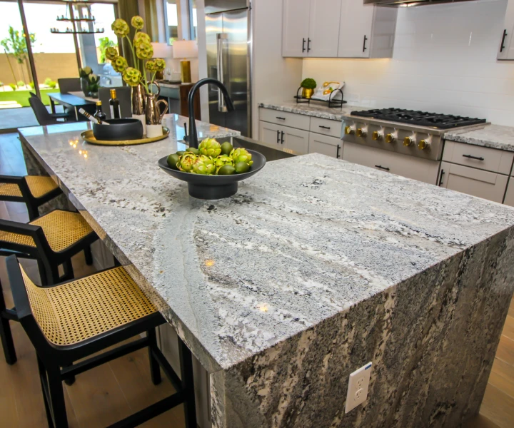 Modern kitchen with granite island countertop.
