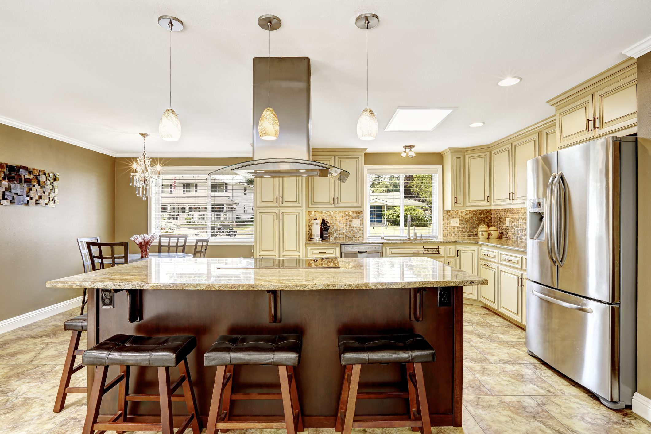 Spacious kitchen with island, wooden cabinets, and natural light.
