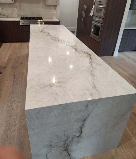 Sleek marble kitchen island with elegant veining and modern design.
